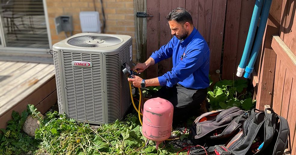 Comfort Zone technician servicing an air conditioning unit